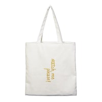 a white tote bag with gold lettering